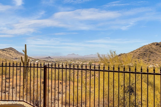 view of yard featuring fence and a mountain view