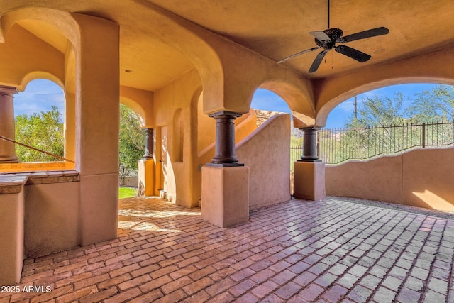 view of patio featuring ceiling fan and fence