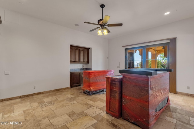 bar featuring recessed lighting, stone tile floors, a ceiling fan, baseboards, and wet bar