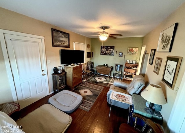 living room with dark hardwood / wood-style floors and ceiling fan