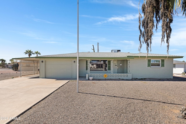 ranch-style house featuring a carport and a garage