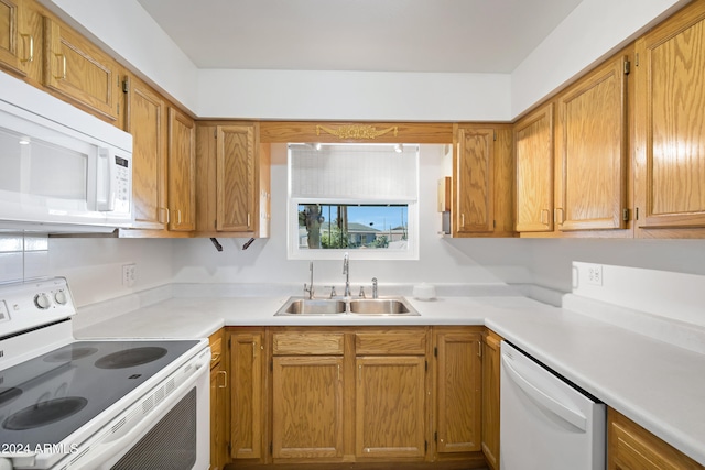 kitchen featuring sink and white appliances