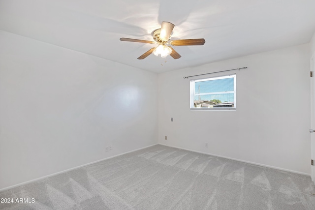 empty room featuring light colored carpet and ceiling fan