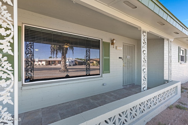 view of exterior entry featuring a porch