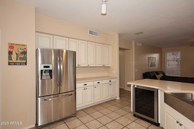 21840 N 43rd St, Phoenix, AZ 85050 - kitchen featuring light countertops, visible vents, stainless steel refrigerator with ice dispenser, and beverage cooler