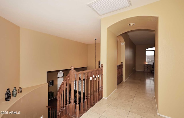 21840 N 43rd St, Phoenix, AZ 85050 - hall with an upstairs landing, light tile patterned floors, baseboards, arched walkways, and visible vents
