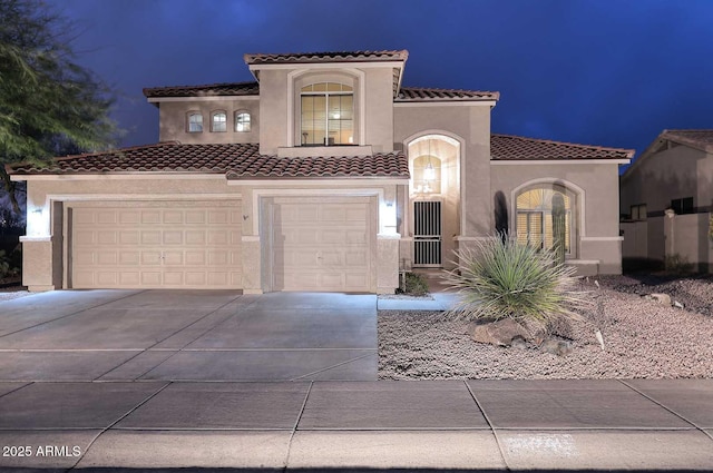 21840 N 43rd St, Phoenix, AZ 85050 - mediterranean / spanish-style house featuring driveway, an attached garage, a tiled roof, and stucco siding