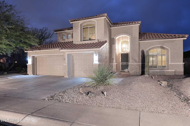 21840 N 43rd St, Phoenix, AZ 85050 - mediterranean / spanish home with a tile roof, stucco siding, a garage, and concrete driveway