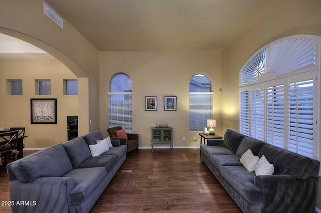 21840 N 43rd St, Phoenix, AZ 85050 - living room with dark wood-style floors, visible vents, arched walkways, and baseboards