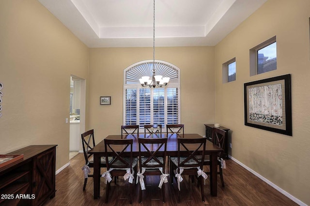 21840 N 43rd St, Phoenix, AZ 85050 - dining space with baseboards, dark wood-style flooring, a tray ceiling, and an inviting chandelier