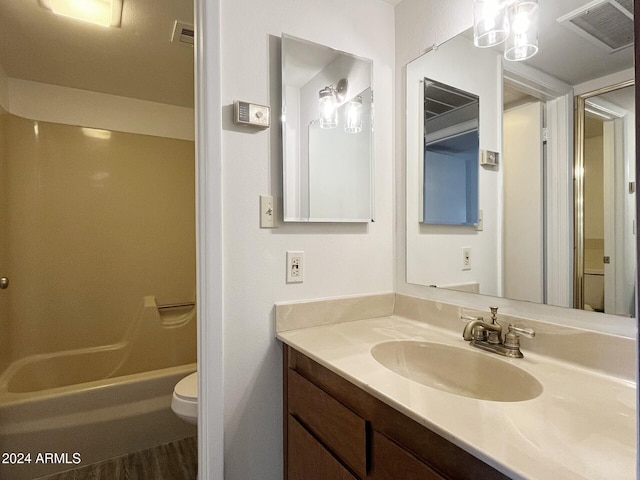 full bathroom featuring vanity, wood-type flooring,  shower combination, and toilet