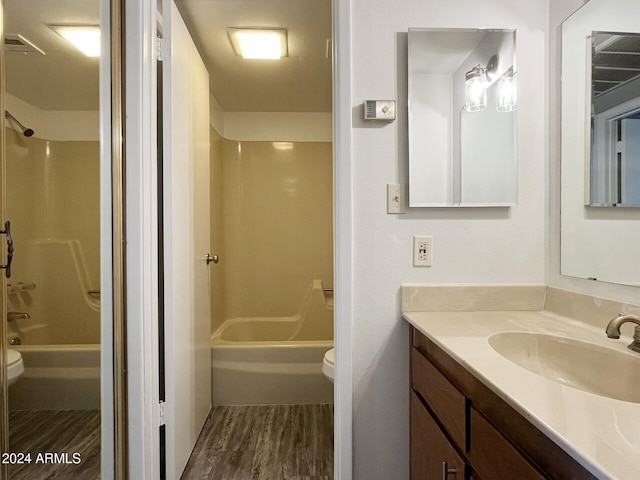 full bathroom featuring shower / bath combination, vanity, wood-type flooring, and toilet