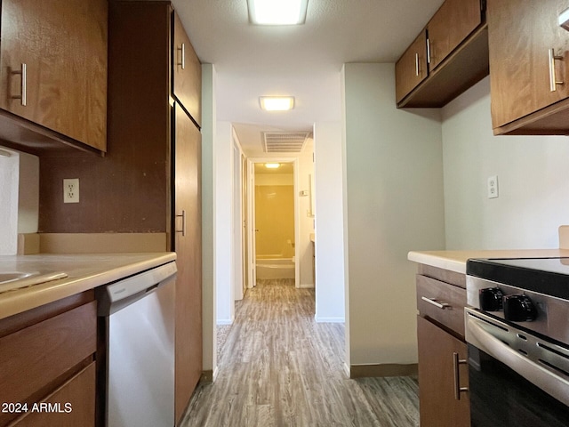 kitchen featuring stainless steel appliances and light hardwood / wood-style flooring