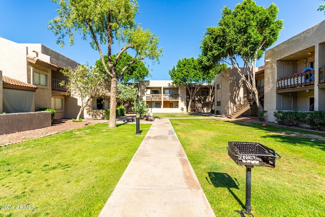 view of home's community with a lawn