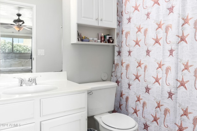 bathroom with large vanity, ceiling fan, and toilet