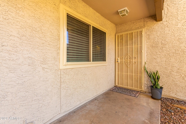 property entrance featuring a patio area