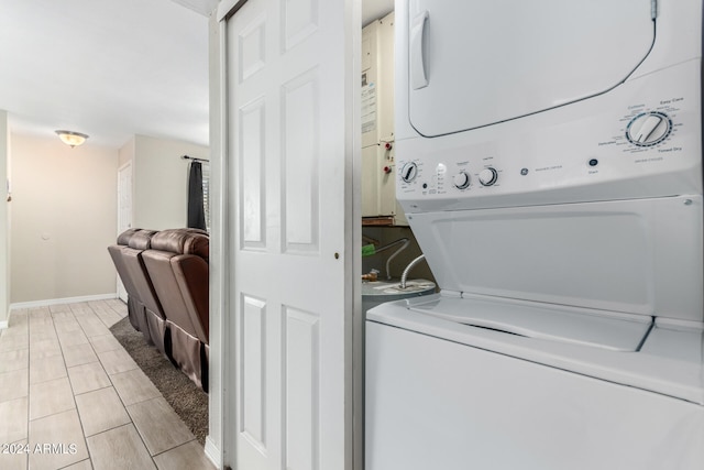 washroom featuring stacked washer / dryer