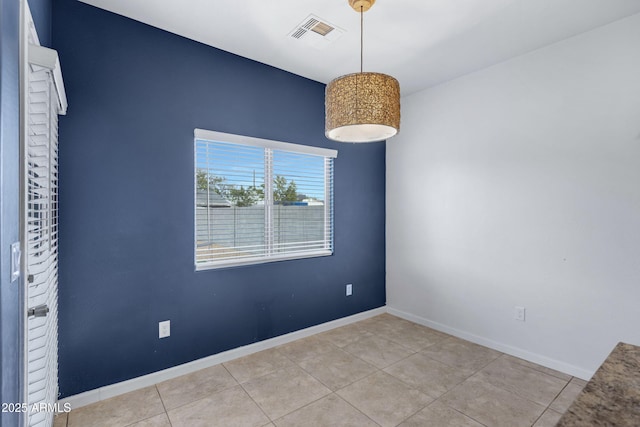 tiled spare room with baseboards and visible vents