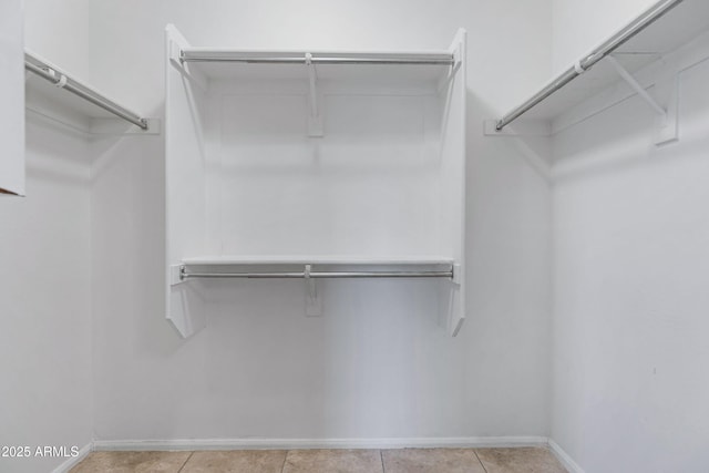 spacious closet featuring light tile patterned flooring