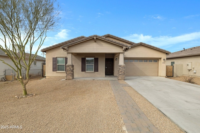 view of front of home featuring concrete driveway, fence, an attached garage, and stucco siding