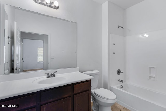 full bath featuring washtub / shower combination, tile patterned flooring, vanity, and toilet