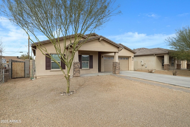 view of front of house with a garage, fence, concrete driveway, a gate, and stucco siding