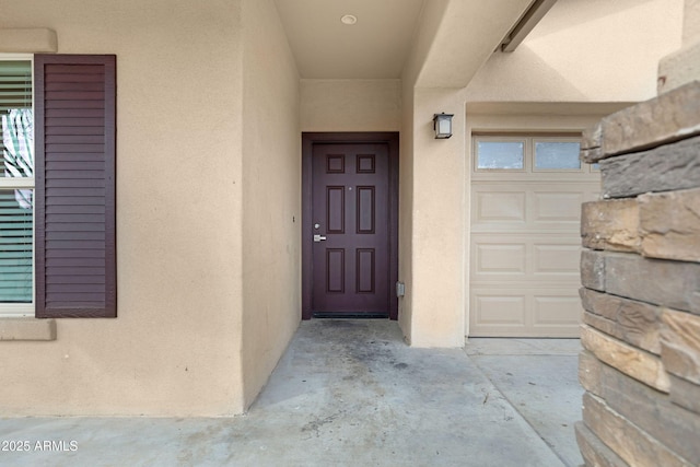 property entrance with stucco siding