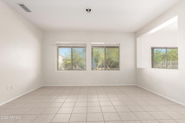 unfurnished room with light tile patterned floors