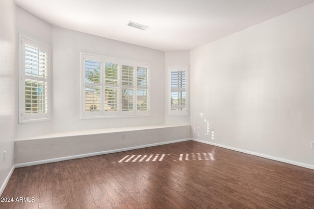 spare room with dark wood-type flooring