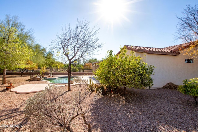 view of yard featuring a fenced in pool and a patio