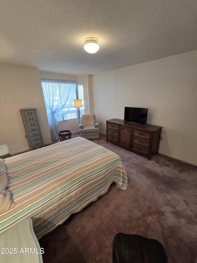 bedroom with baseboards, carpet, and a textured ceiling