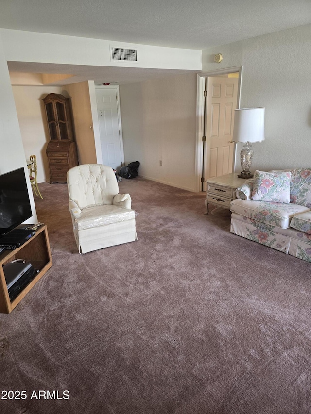 carpeted living area featuring visible vents