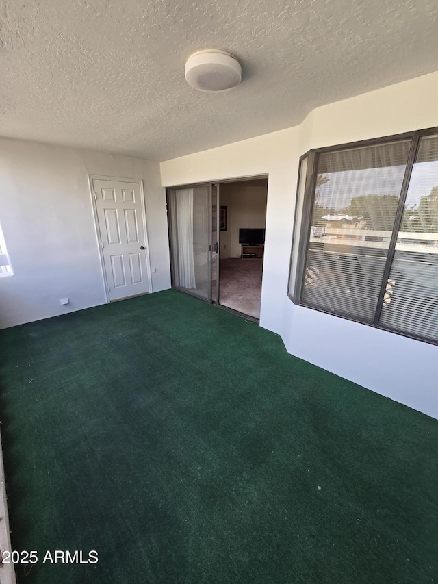 unfurnished bedroom featuring a closet, carpet, and a textured ceiling