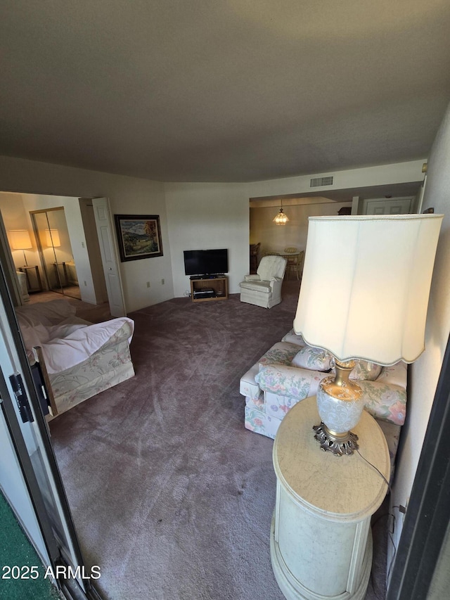 living room with visible vents and carpet floors