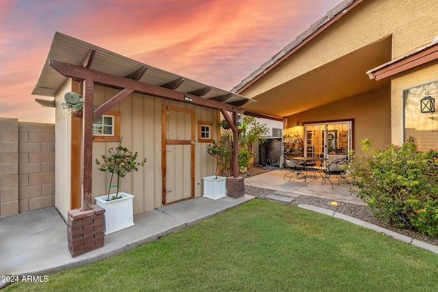 yard at dusk with a patio area