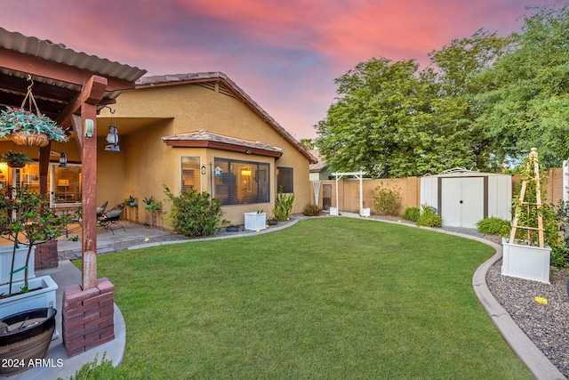 yard at dusk featuring a patio area and a shed