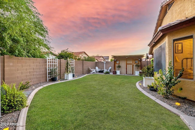 yard at dusk with a storage shed