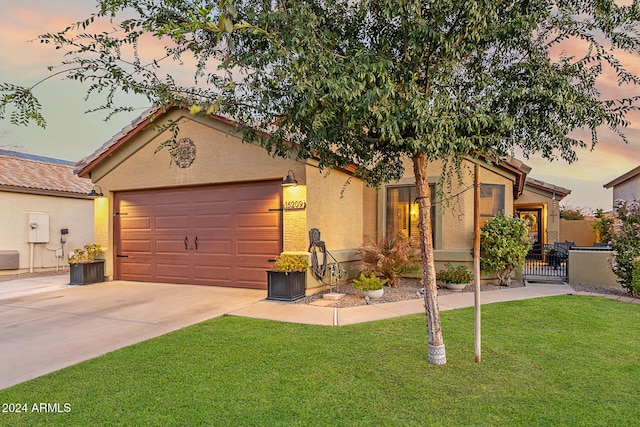 view of front of home featuring a yard and a garage