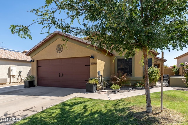 view of front of house with a garage and a front yard