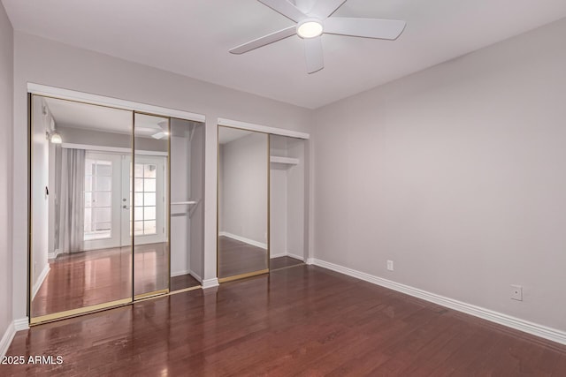 1173 E Cochise Dr, Phoenix, AZ 85020 - unfurnished bedroom featuring wood finished floors, baseboards, two closets, and a ceiling fan