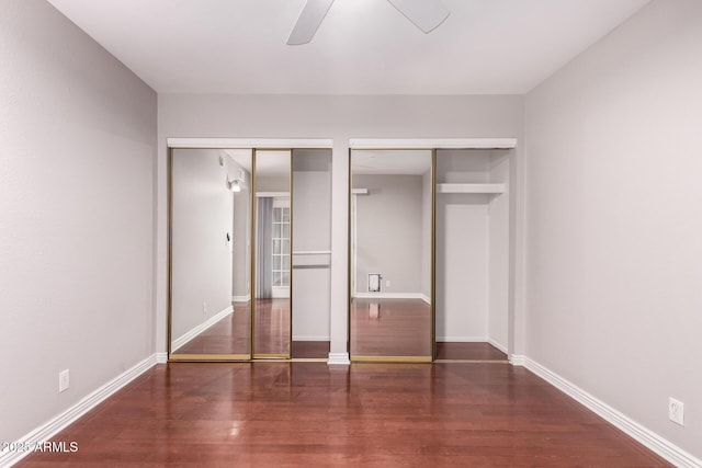 1173 E Cochise Dr, Phoenix, AZ 85020 - unfurnished bedroom featuring wood finished floors, two closets, and baseboards
