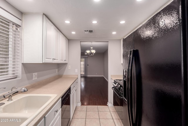 1173 E Cochise Dr, Phoenix, AZ 85020 - kitchen featuring black appliances, a sink, recessed lighting, a chandelier, and white cabinets