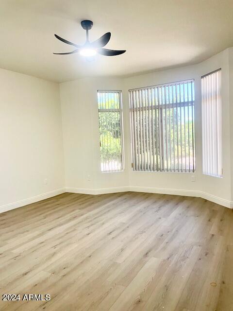 empty room featuring ceiling fan and light hardwood / wood-style flooring