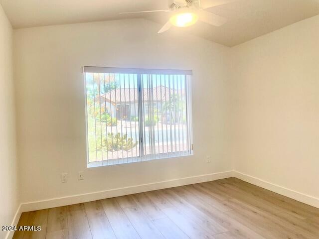 spare room featuring hardwood / wood-style floors, ceiling fan, and lofted ceiling