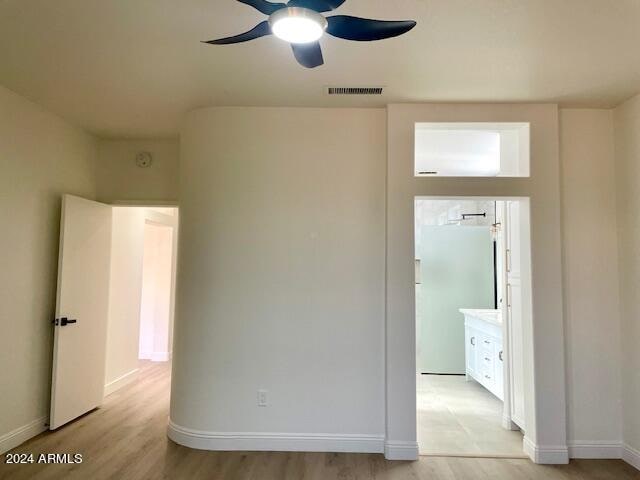 empty room featuring ceiling fan and light wood-type flooring