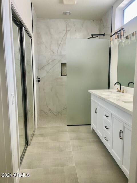 bathroom with vanity and tiled shower