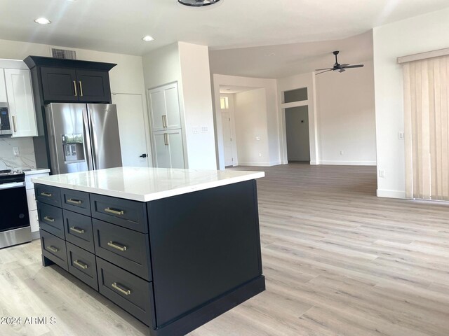 kitchen with a center island, stainless steel appliances, ceiling fan, and light hardwood / wood-style floors