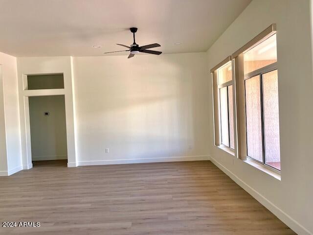 spare room with ceiling fan and light hardwood / wood-style flooring