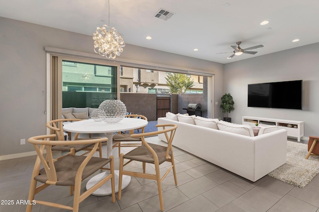 living room featuring ceiling fan with notable chandelier