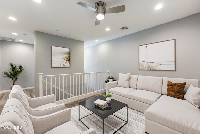 living room featuring wood-type flooring and ceiling fan